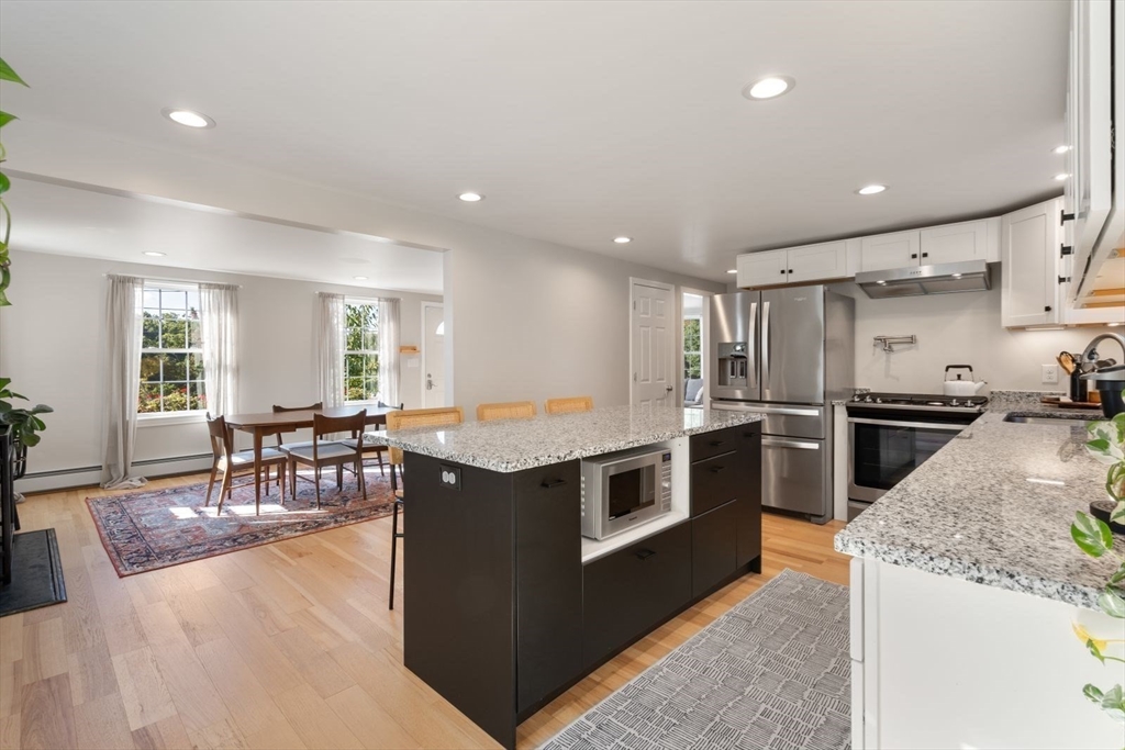 31 Broad Cove Road Hingham, MA 02043 - Photo 3 of 22 a kitchen with stainless steel appliances granite countertop a stove and a refrigerator