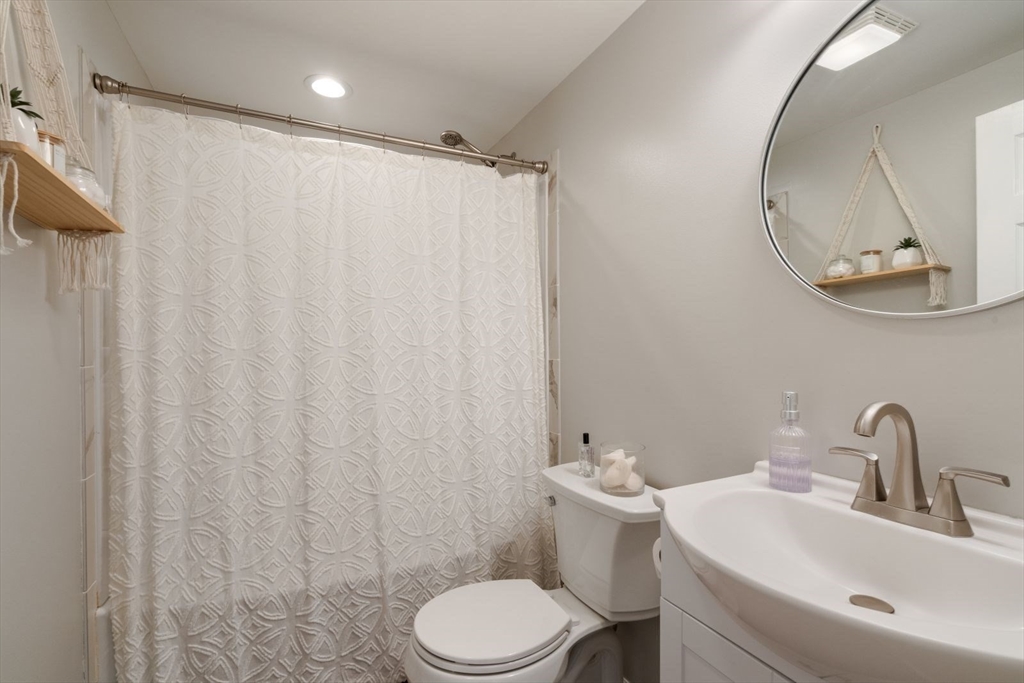 31 Broad Cove Road Hingham, MA 02043 - Photo 10 of 22 a bathroom with a sink a toilet and a mirror