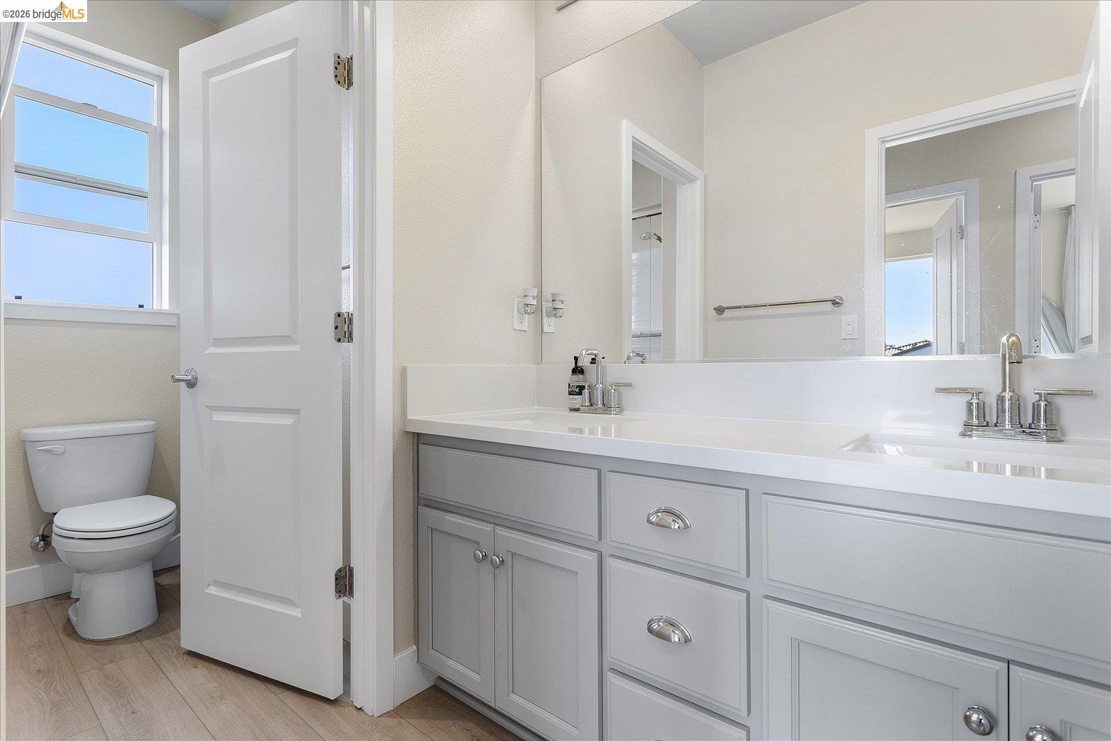 5601 Ridgepoint Way Antioch, CA 94531 - Photo 31 of 59 Dual vanity with integrated sinks, light gray cabinetry, and polished chrome fixtures