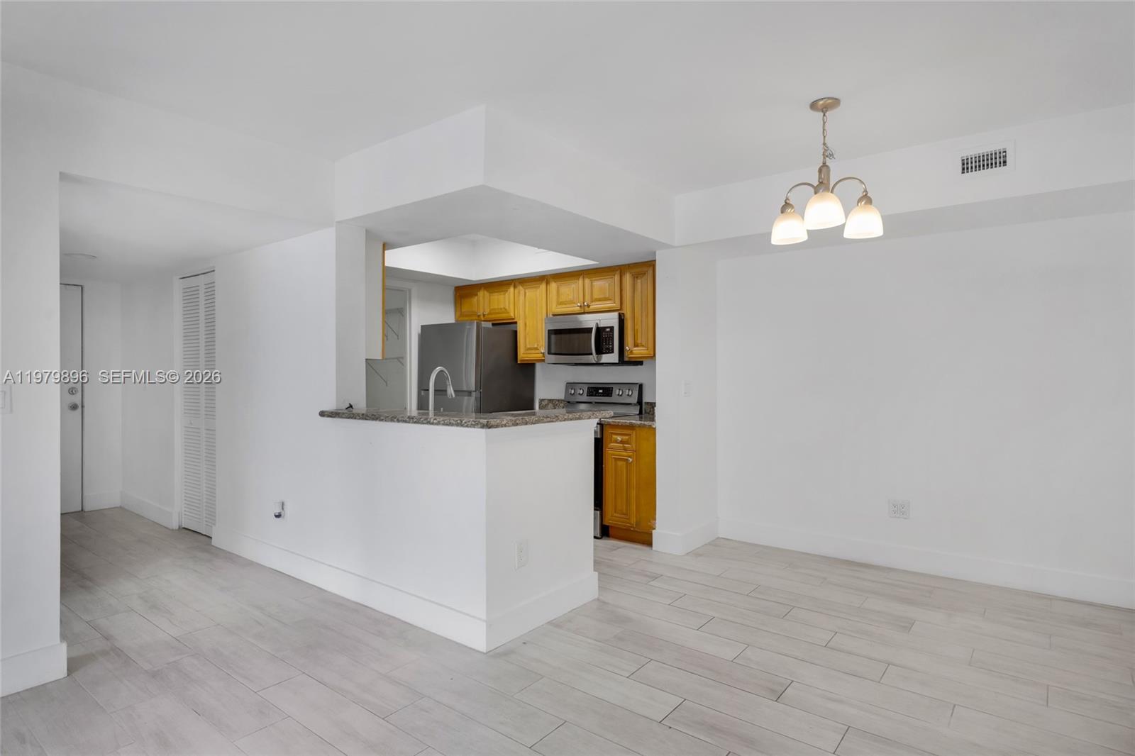 5760 Rock Island Road, Unit 321 Tamarac, FL 33319 - Photo 15 of 36 a view of a kitchen with granite countertop cabinets and stainless steel appliances