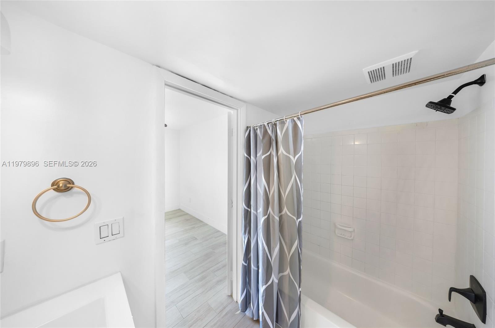 5760 Rock Island Road, Unit 321 Tamarac, FL 33319 - Photo 19 of 36 a bathroom with a shower and a bathtub