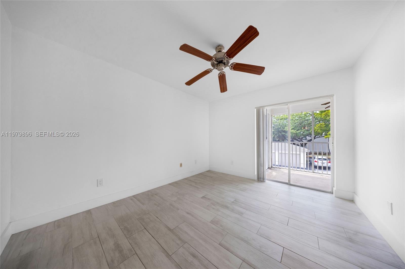 5760 Rock Island Road, Unit 321 Tamarac, FL 33319 - Photo 22 of 36 wooden floor in an empty room with a window