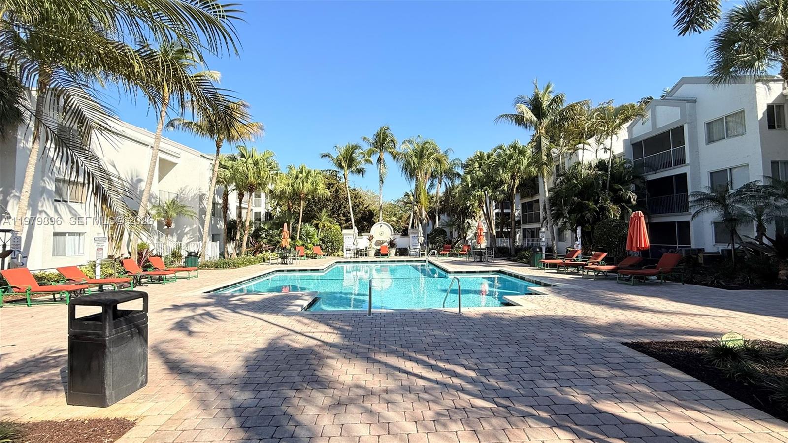 5760 Rock Island Road, Unit 321 Tamarac, FL 33319 - Photo 27 of 36 a view of a swimming pool with a lounge chairs