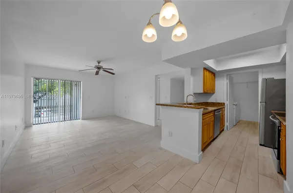 a view of a kitchen with microwave and cabinets