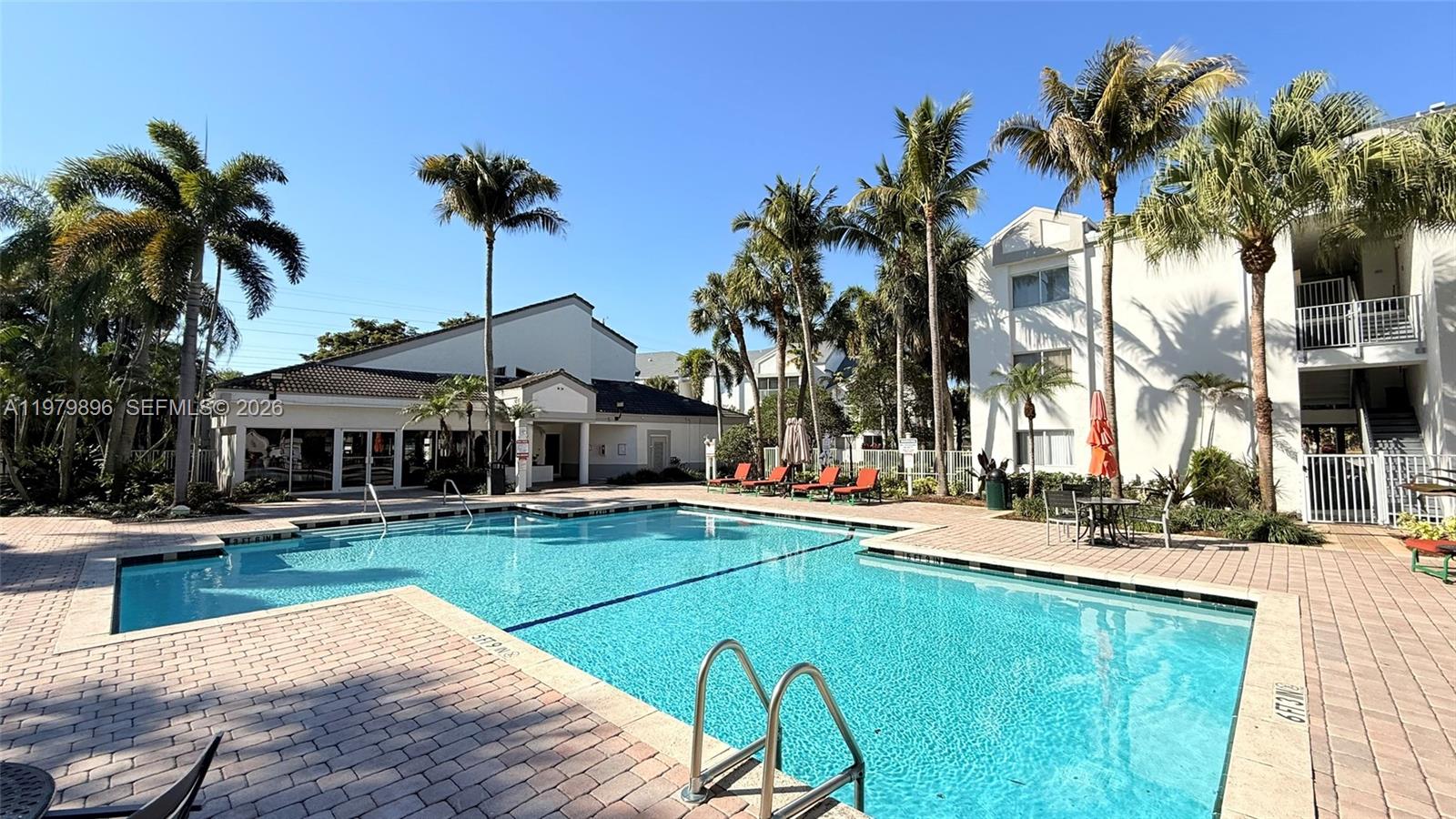 5760 Rock Island Road, Unit 321 Tamarac, FL 33319 - Photo 31 of 36 a view of a house with swimming pool and sitting area