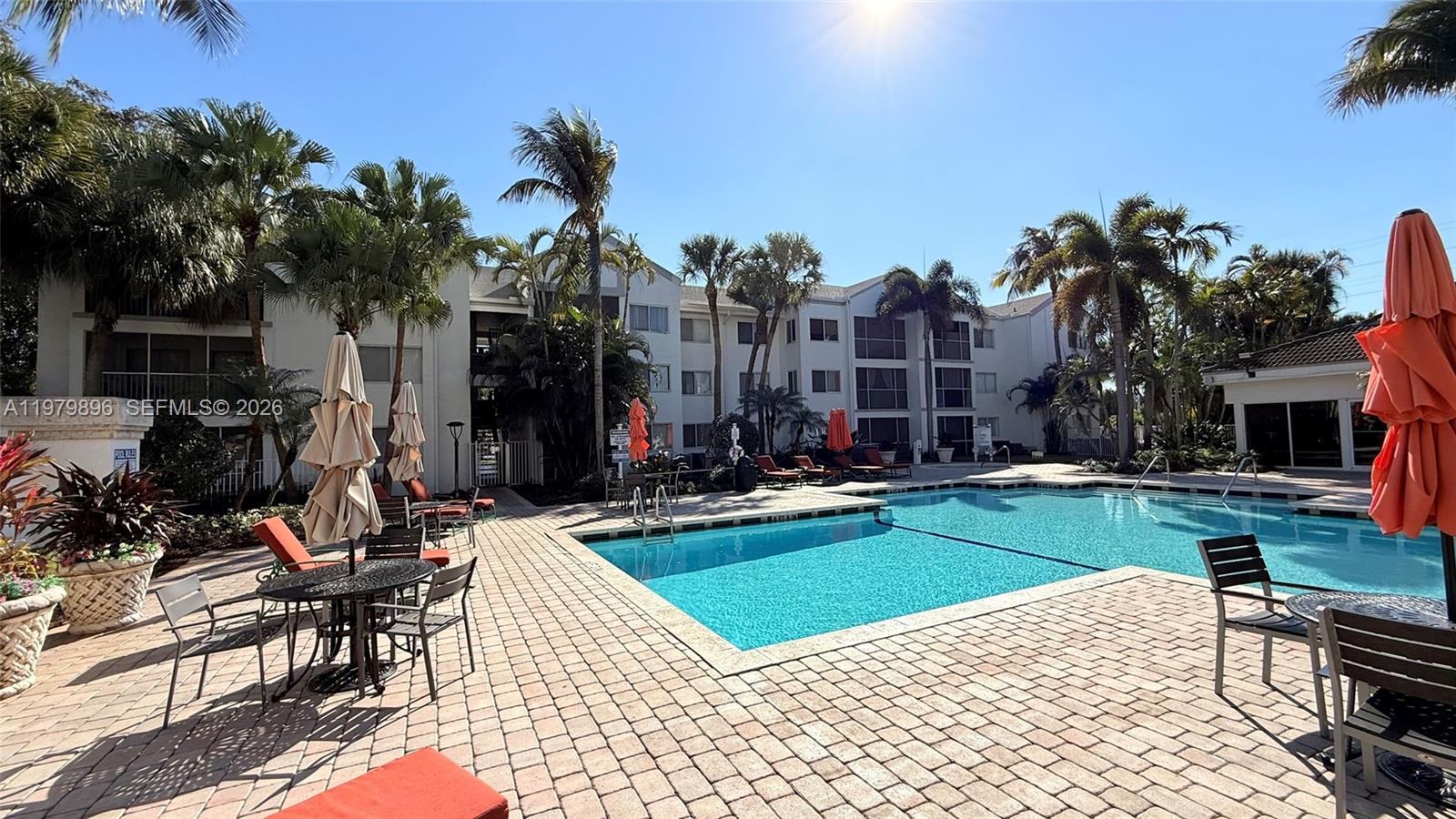 5760 Rock Island Road, Unit 321 Tamarac, FL 33319 - Photo 32 of 36 a view of a house with swimming pool and sitting area