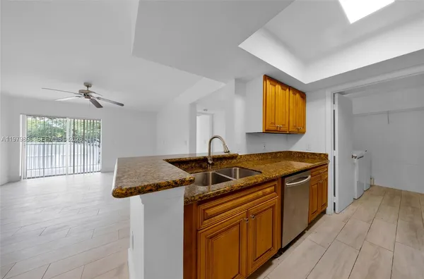 a kitchen with stainless steel appliances granite countertop a sink stove and cabinets