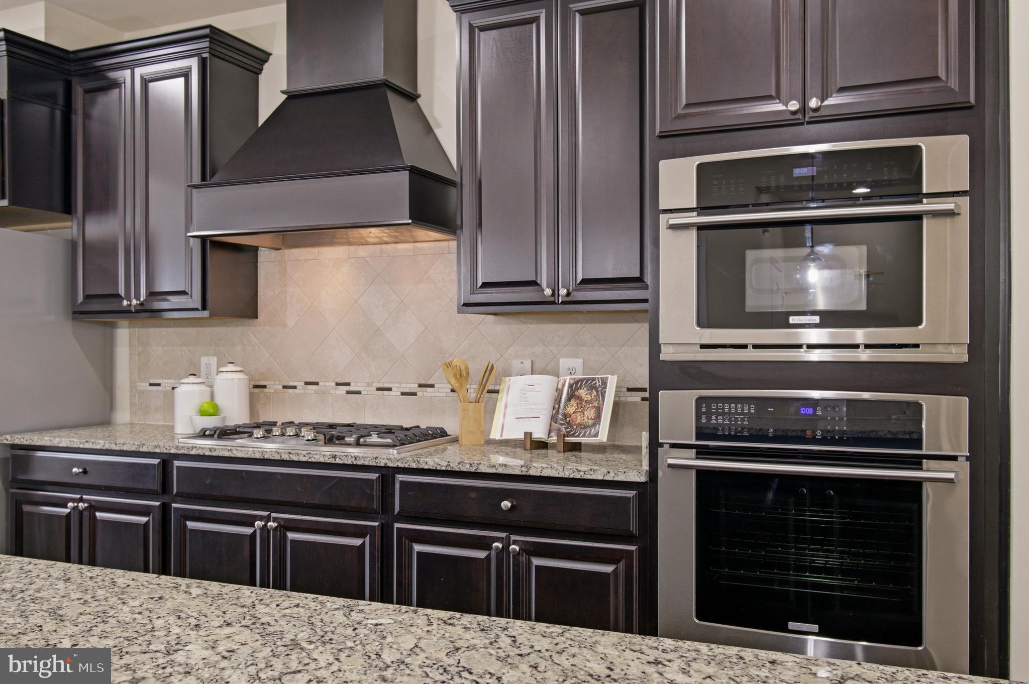 7015 Starwort Way, Unit A Hanover, MD 21076 - Photo 20 of 69 a kitchen with granite countertop a stove microwave and sink
