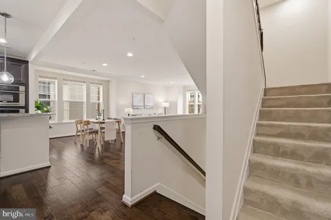a spacious bathroom with a granite countertop toilet a sink and a mirror