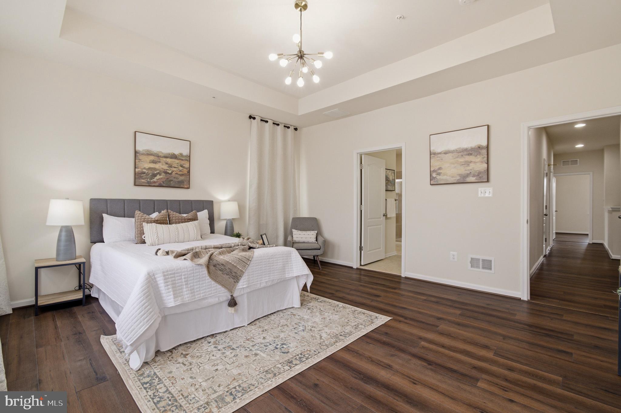 7015 Starwort Way, Unit A Hanover, MD 21076 - Photo 36 of 69 a spacious bedroom with a bed and wooden floor