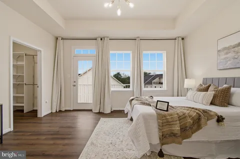 a view of a room with wooden floor and a ceiling fan