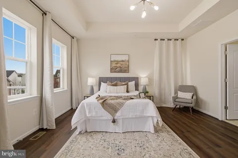 a bedroom with bed and a chandelier