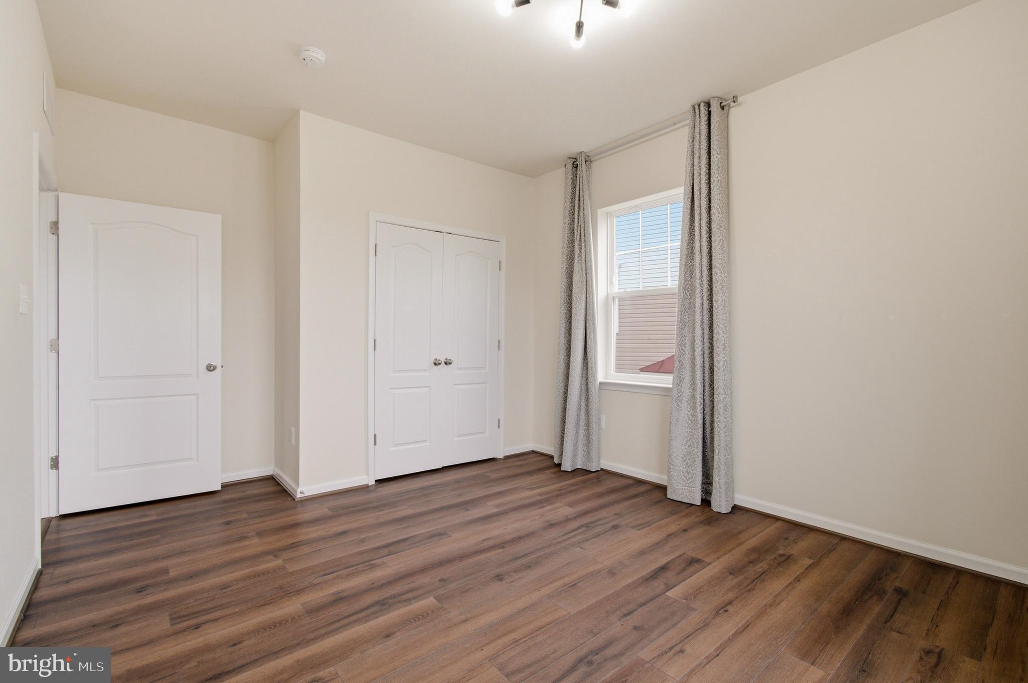 7015 Starwort Way, Unit A Hanover, MD 21076 - Photo 47 of 69 an empty room with wooden floor