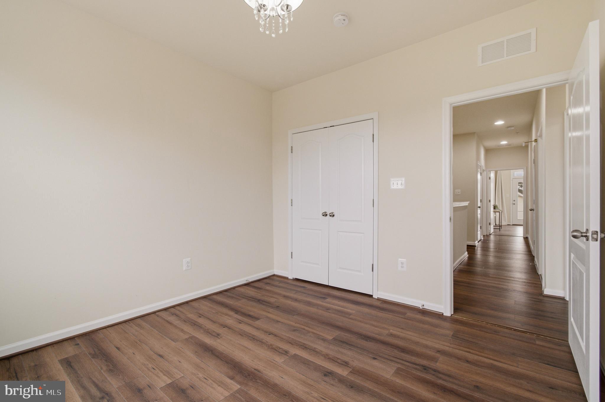 7015 Starwort Way, Unit A Hanover, MD 21076 - Photo 48 of 69 a view of a room with wooden floor and a ceiling fan