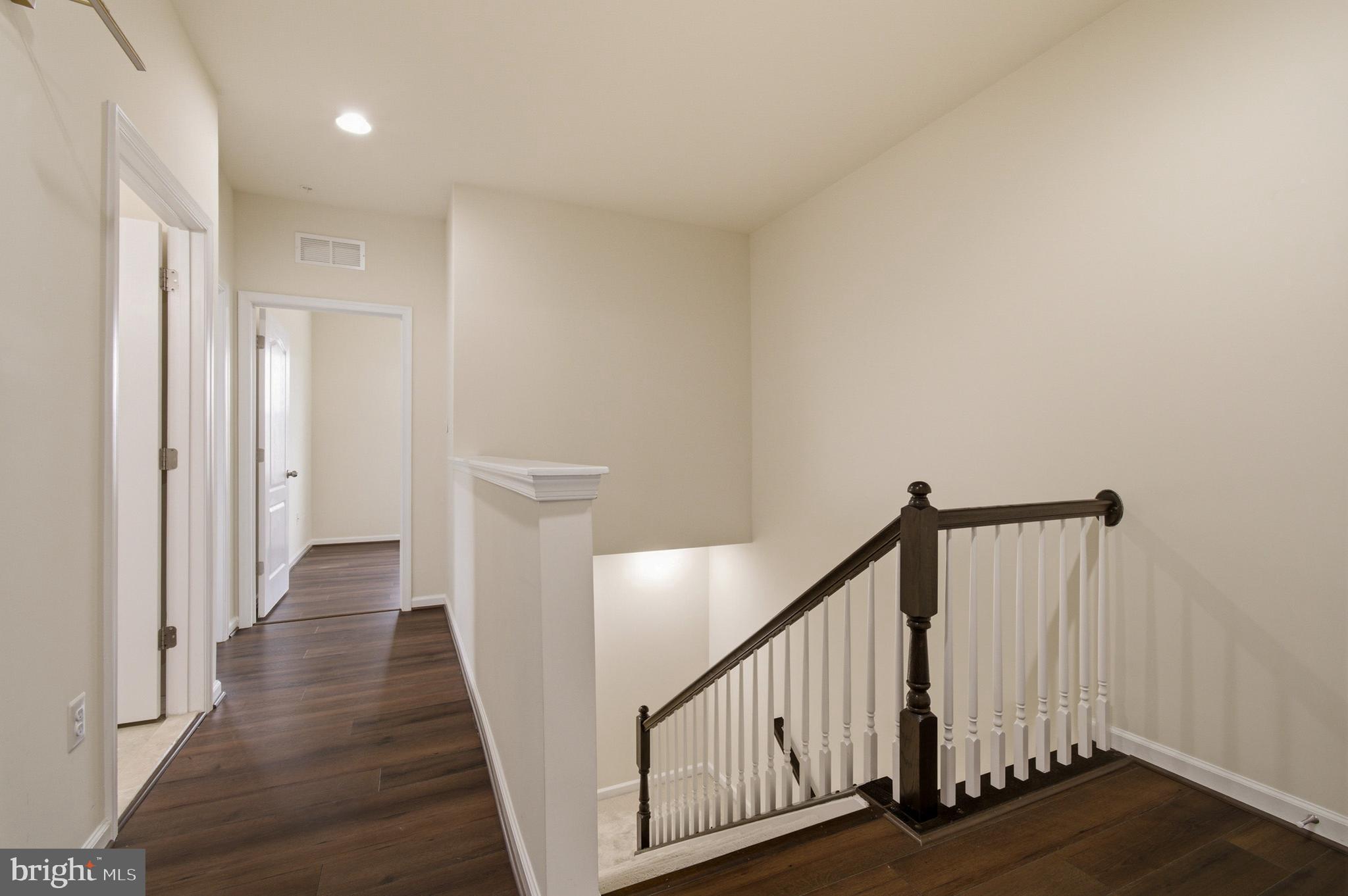 7015 Starwort Way, Unit A Hanover, MD 21076 - Photo 50 of 69 a view of a hallway with wooden floor and staircase