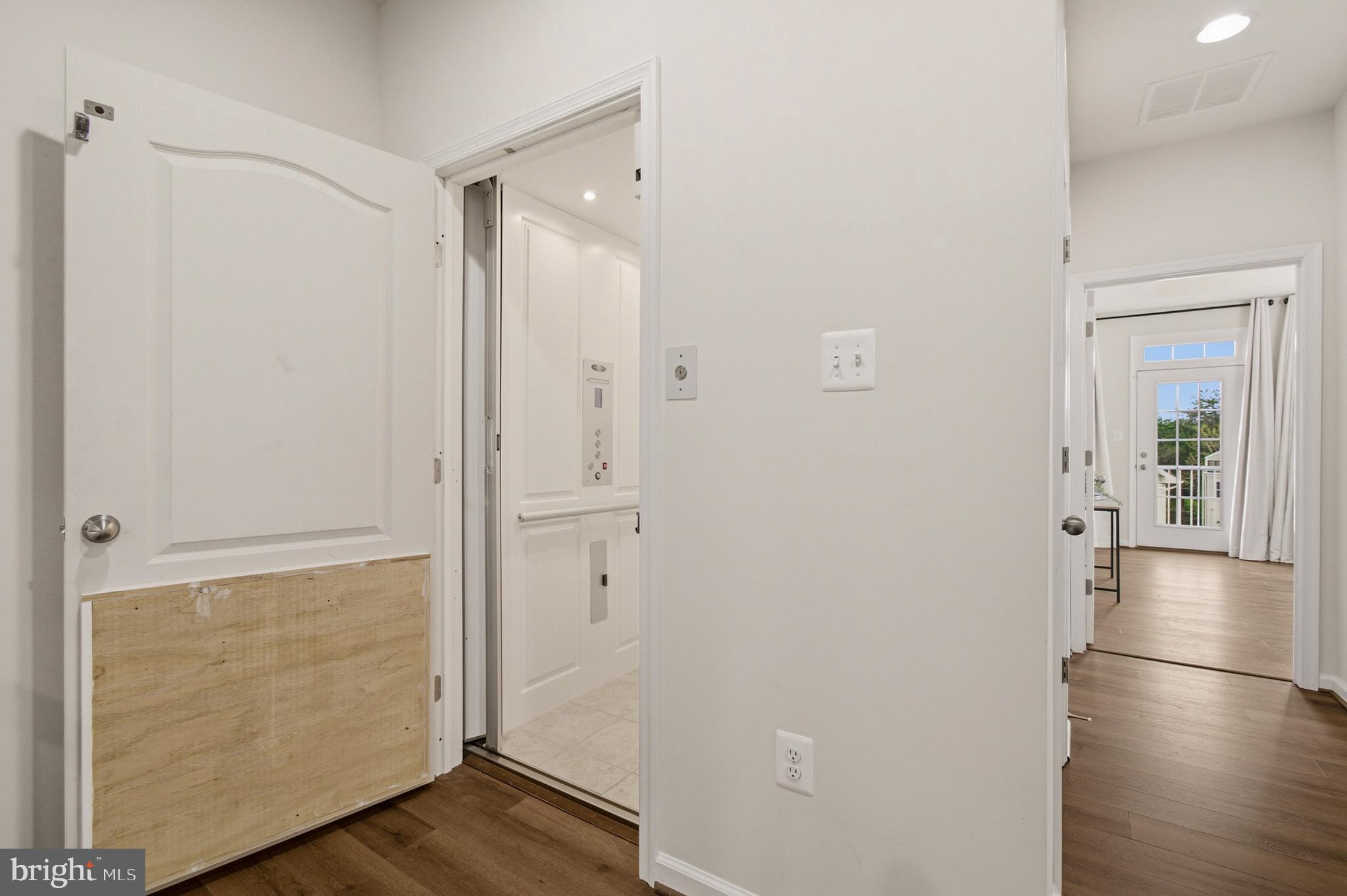 7015 Starwort Way, Unit A Hanover, MD 21076 - Photo 53 of 69 a view of a hallway with wooden floor