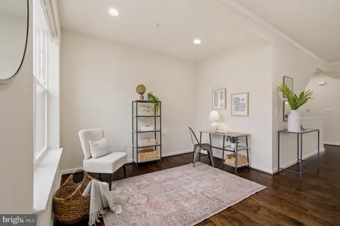 a living room with furniture a window and a flat screen tv