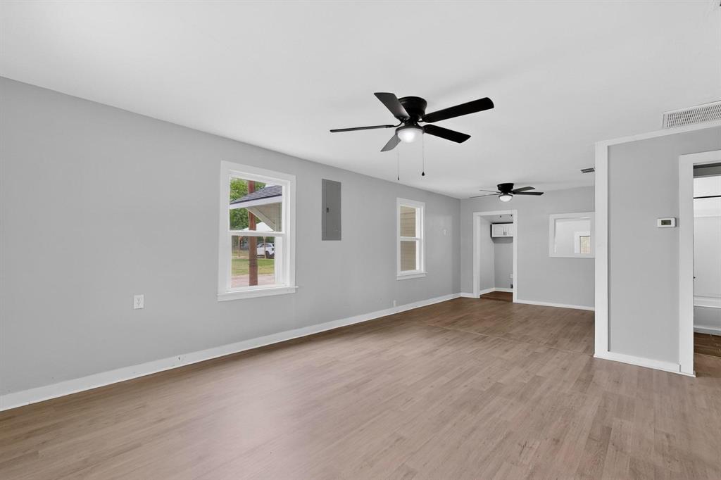 313 Farm To Market 316 Eustace, TX 75124 - Photo 7 of 33 a view of a big room with wooden floor and windows