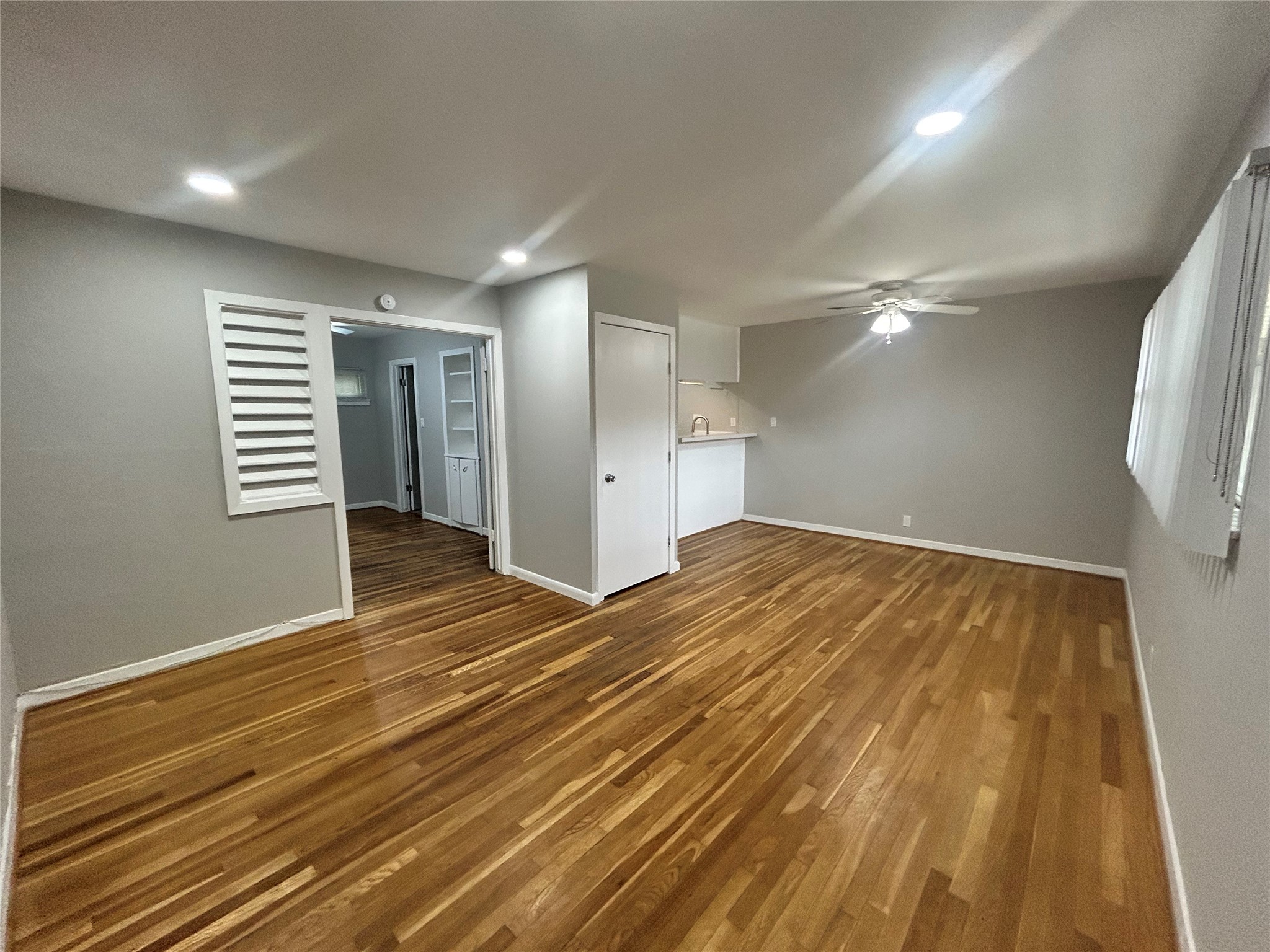a view of empty room with wooden floor