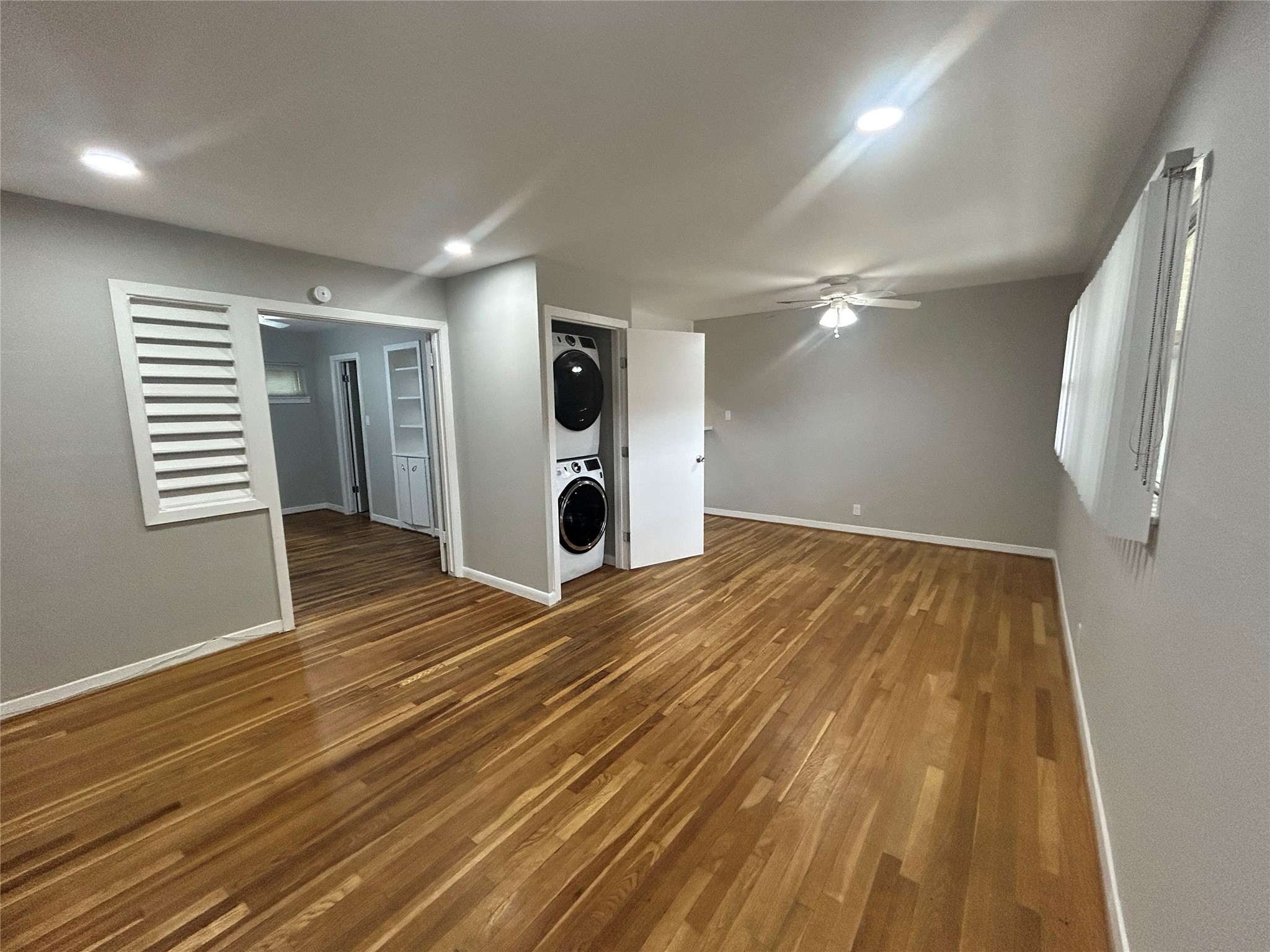 3520 Garrott Street, Unit 3 Houston, TX 77006 - Photo 2 of 12 an empty room with wooden floor and windows