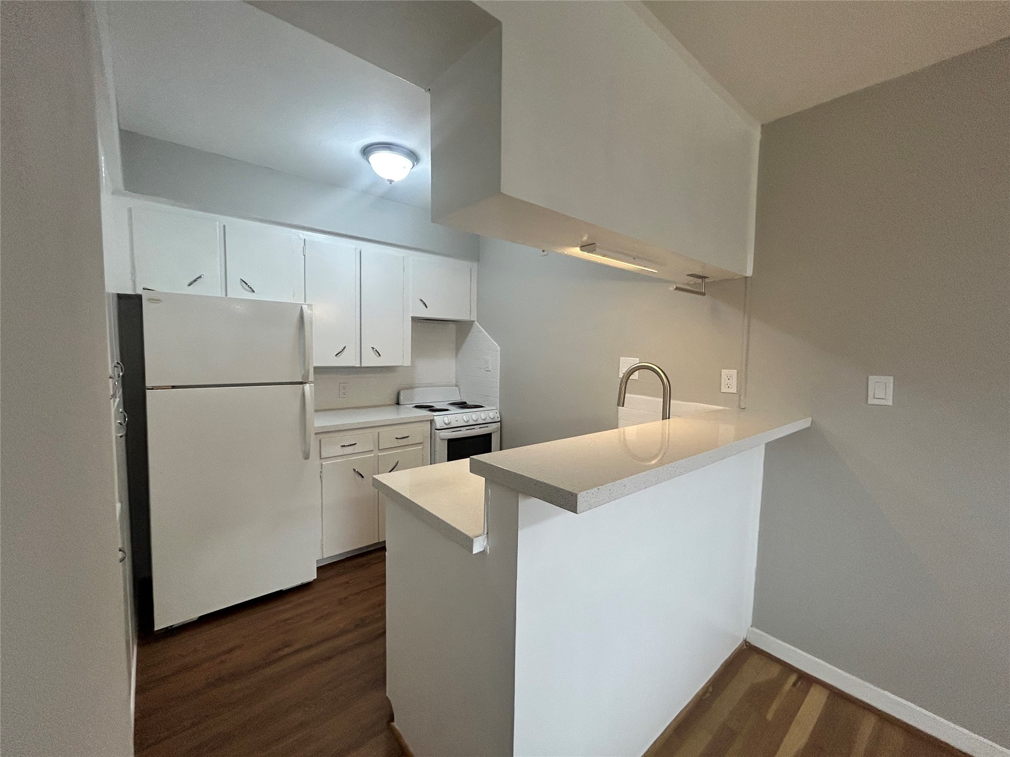 3520 Garrott Street, Unit 3 Houston, TX 77006 - Photo 3 of 12 a kitchen with refrigerator and white cabinets