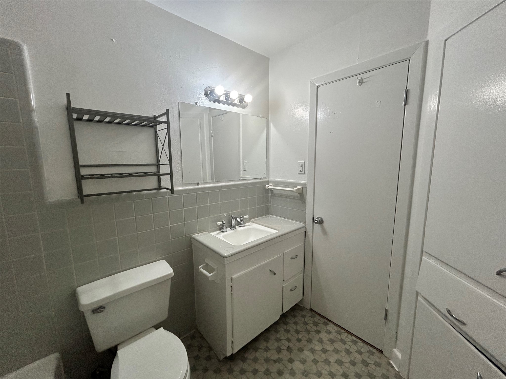 3520 Garrott Street, Unit 3 Houston, TX 77006 - Photo 8 of 12 a bathroom with a toilet sink vanity and mirror
