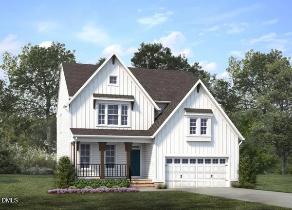 a view of white house with a yard and potted plants