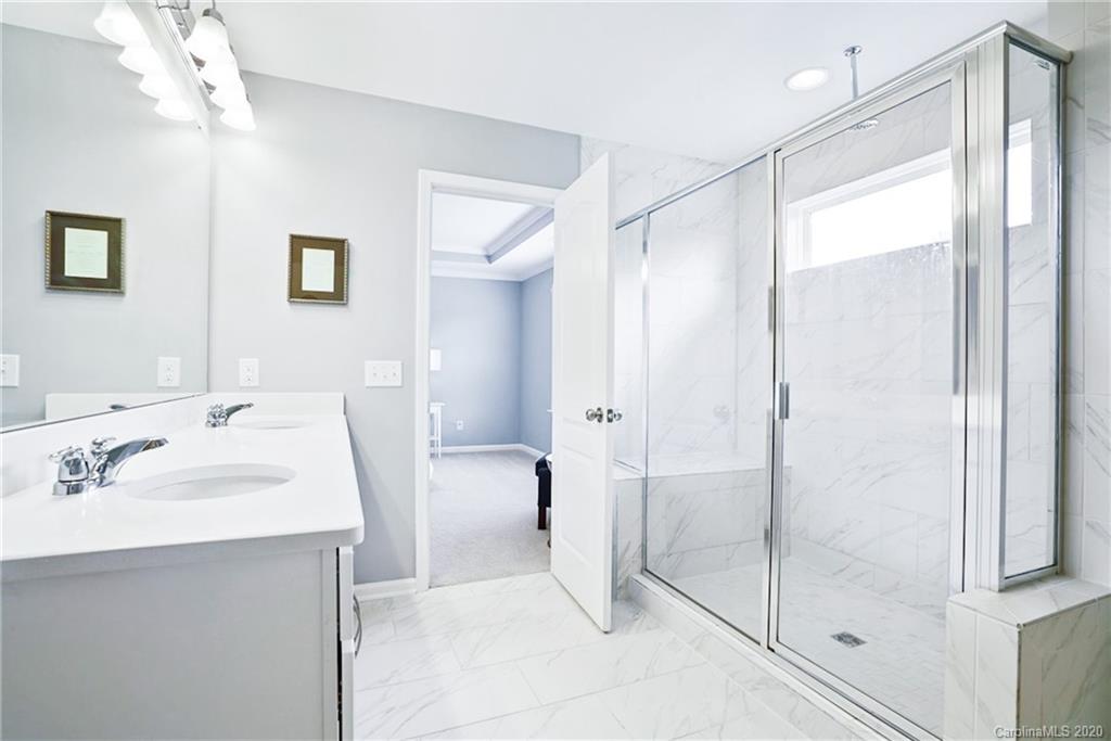 210 Hampton Trail Drive Fort Mill, SC 29708 - Photo 22 of 24 a bathroom with a shower sink and mirror
