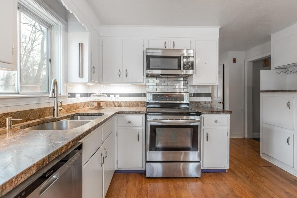 20 Argilla Road Ipswich, MA 01938 - Photo 6 of 33 a kitchen with white cabinets appliances and sink