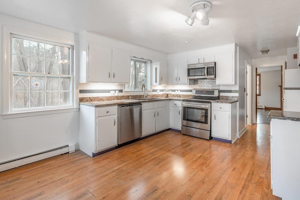 20 Argilla Road Ipswich, MA 01938 - Photo 7 of 33 a kitchen with stainless steel appliances granite countertop a stove top oven a sink dishwasher and a refrigerator