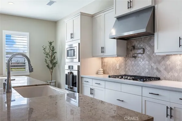 a kitchen with cabinets and a stove