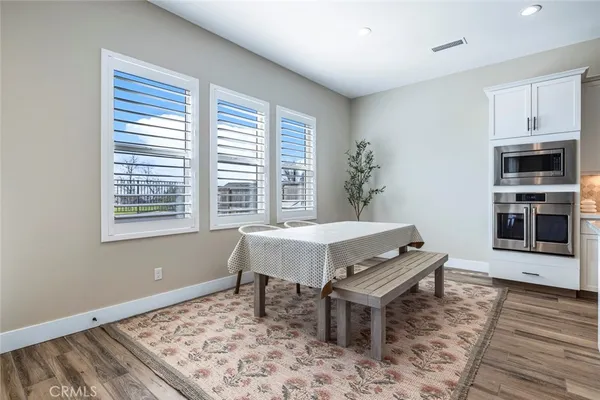 a dining room with a wooden table and chairs