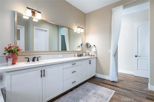 a bathroom with a double vanity sink and mirror