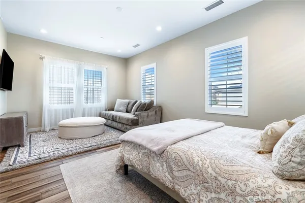 a bedroom with a bed and a couch