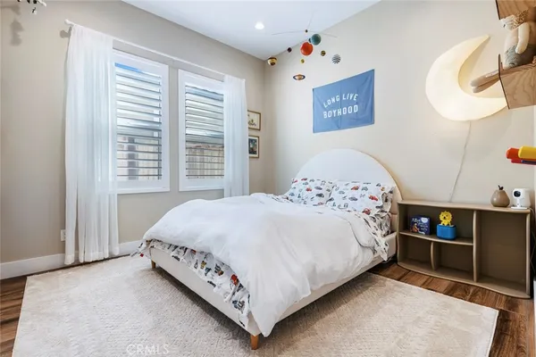 a bed sitting in a bedroom next to a window