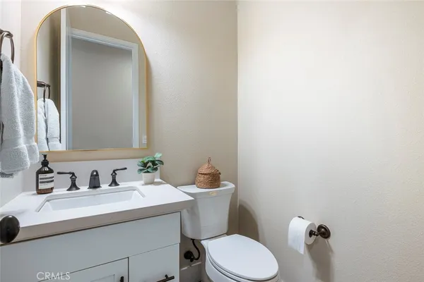 a bathroom with a sink mirror vanity and toilet