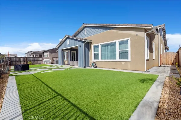 a view of a house with a backyard