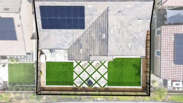 a view of a house with a small yard and wooden fence