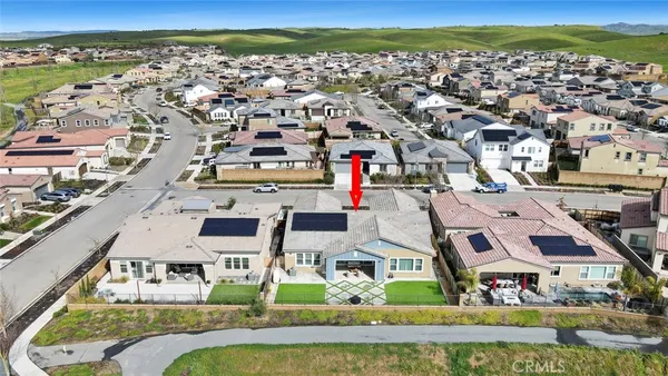 an aerial view of residential houses with outdoor space