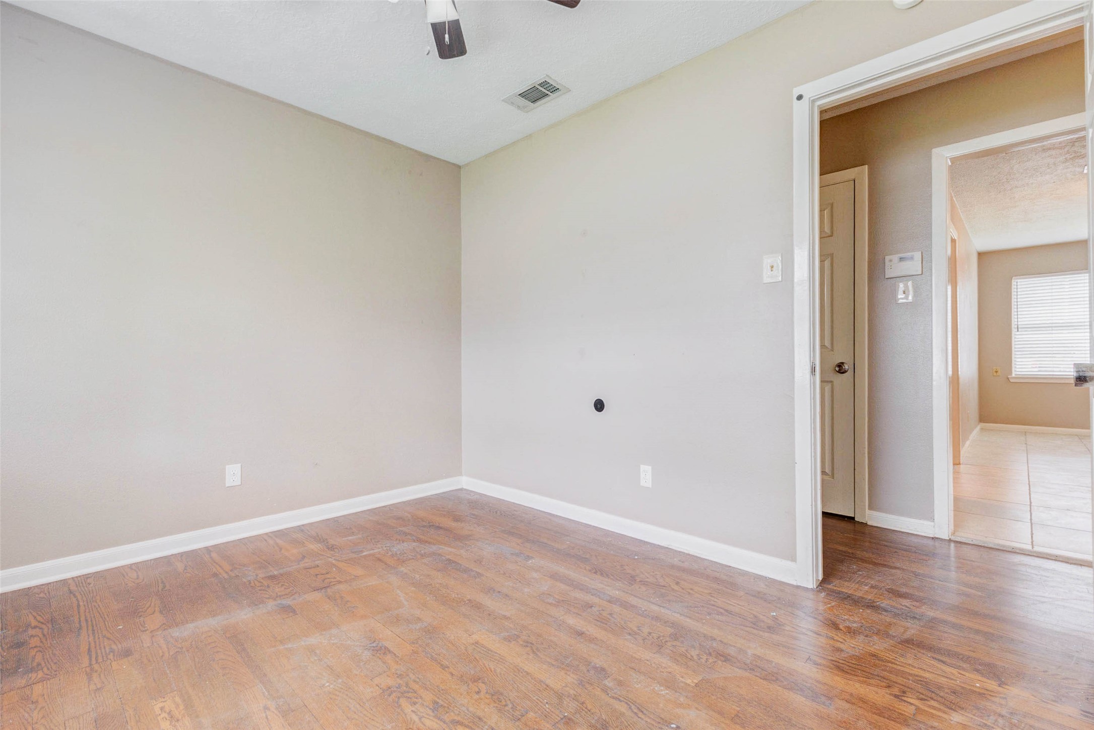 411 Burke Road Pasadena, TX 77506 - Photo 11 of 24 wooden floor in an empty room