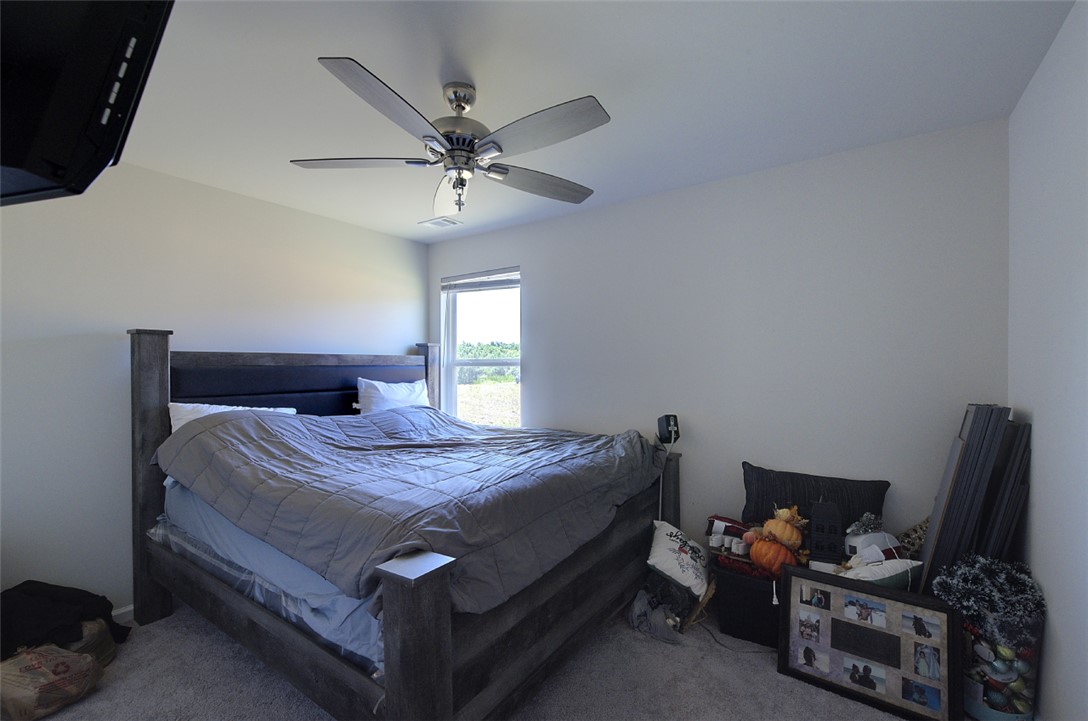 408 Chadwick Lane Walhalla, SC 29691 - Photo 25 of 44 A well-lit bedroom features a single window overlooking green outdoor scenery and a ceiling fan for optimal comfort.