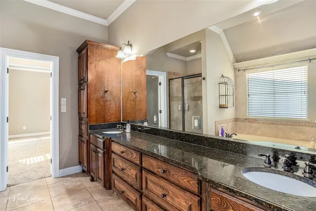 a bathroom with a granite countertop double vanity sink and a mirror