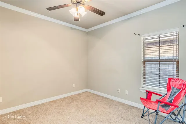 an empty room with windows and furniture