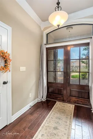 a room with a window and a rug