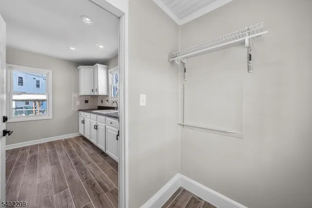 a view of hallway with wooden floor