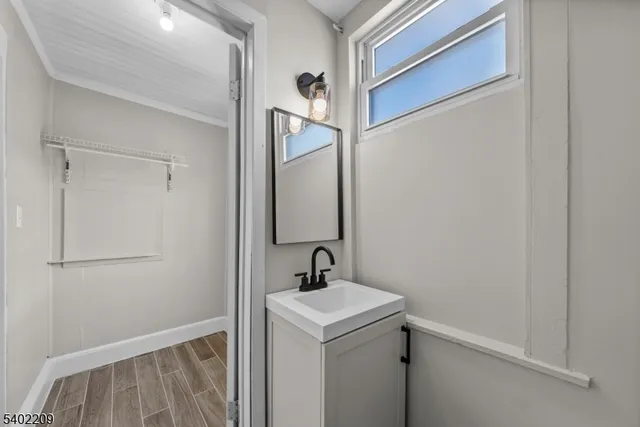 a bathroom with a sink a mirror and shower