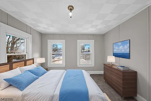 a bedroom with furniture and a window