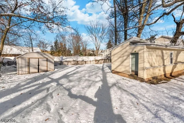 a view of a house with snow on the road