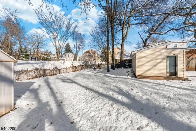 a view of a yard with snow on the road