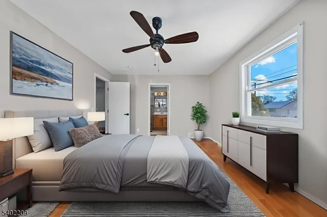 a bedroom with a large bed and a chandelier